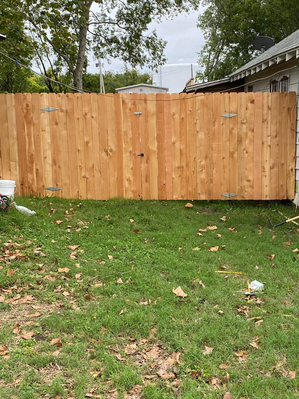 Wood Privacy Fence Installation example — Cedar dog-eared privacy fence with walk gate, Central Texas residential yard